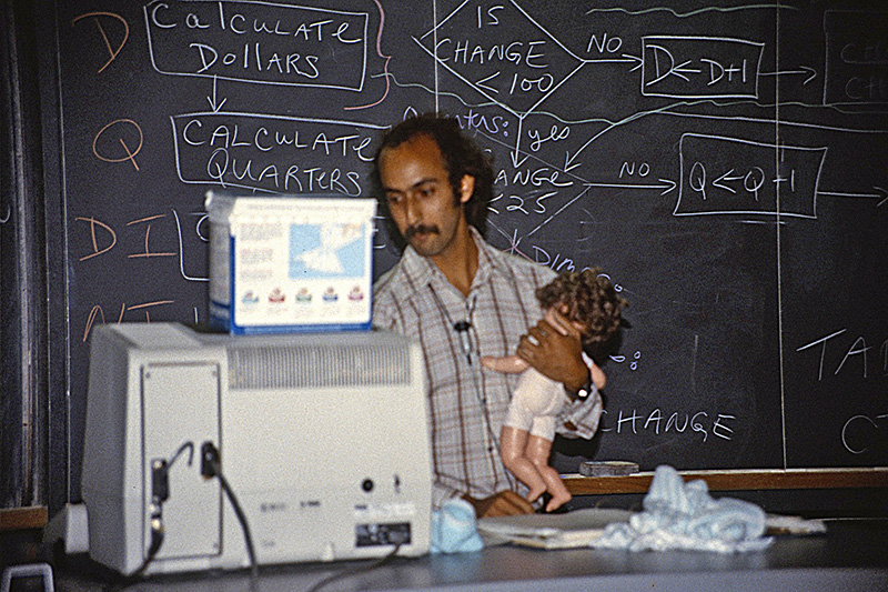 By the early 1990s, Henry Leitner was teaching CS 50 at Harvard. Here he is pictured acting out a facetious algorithm to change a baby's diaper in CS 50. --Courtesy of Henry Leitner.