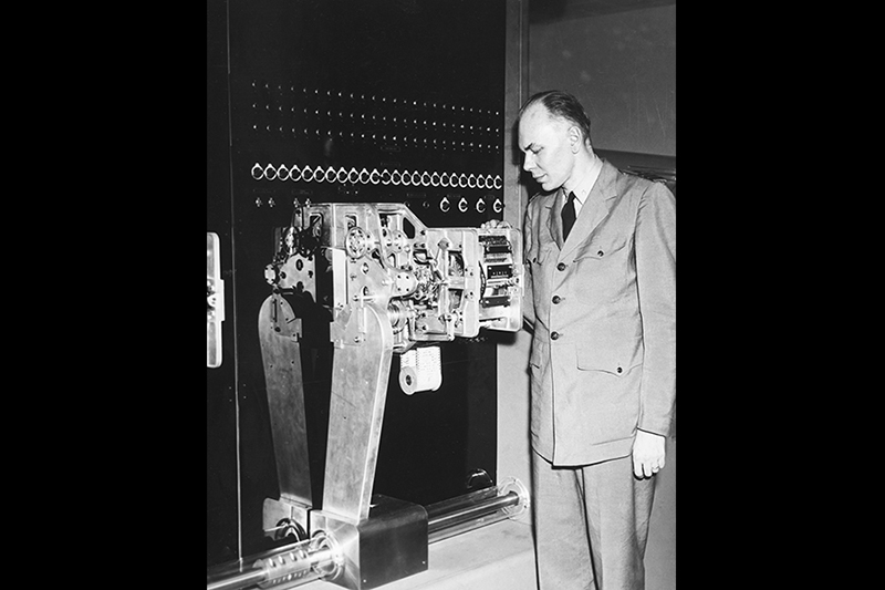 Howard Aiken, a graduate student in Physics, helped launched the field of Computer Science when he wrote a proposal for a giant calculating machine in the 1930s. The finished product—the IBM Automatic Sequence Controlled Calculator, later known as the Harvard Mark I—stood 8 feet high, 51 feet long, and 2 feet wide. Aiken is pictured in 1944 with a section of the Mark I. --Courtesy of the Harvard University Archives (HUP Aiken, Howard H.).