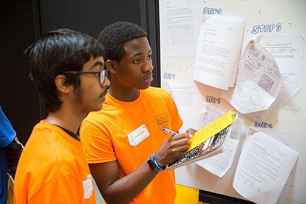 Ibta Chowdhury (left) and Greggy Bazile of Putnam Avenue Upper School prepare to present their project on solar-powered cars. (Kris Snibbe/Harvard Staff Photographer)