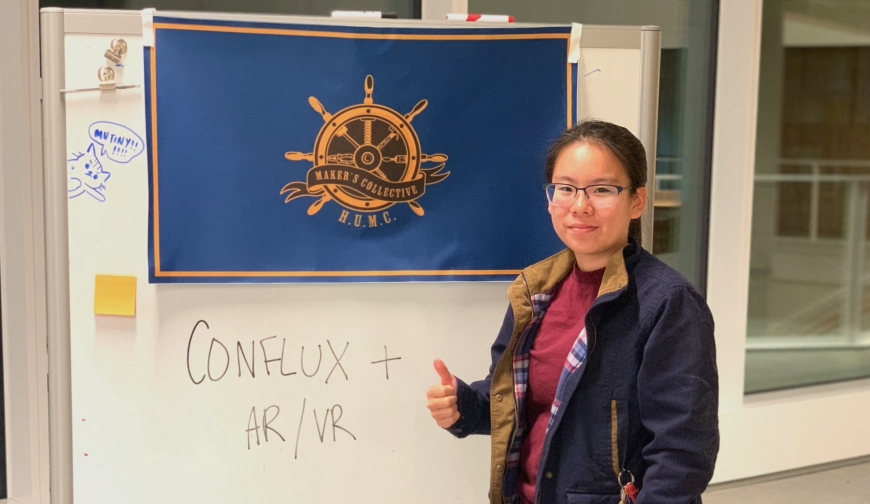 Maker's Collective captain Joy Lin with a club sign