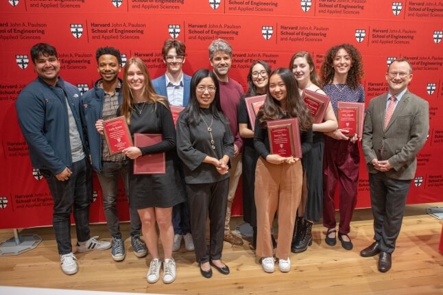 A group of Harvard SEAS seniors with Dean David Parkes, holding awards for outstanding engineering projects