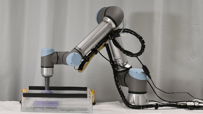 gif of the robotic arm testing the bioinspired suction cups on a substrate. 