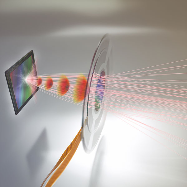 The adaptive metalens focuses light rays onto an image sensor. An electrical signal controls the shape of the metalens to produce the desired optical wavefronts (shown in red), resulting in better images. In the future, adaptive metalenses will be built into imaging systems, such as cell phone cameras and microscope, enabling flat, compact autofocus as well as the capability for simultaneously correcting optical aberrations and performing optical image stabilization, all in a single plane of control. 