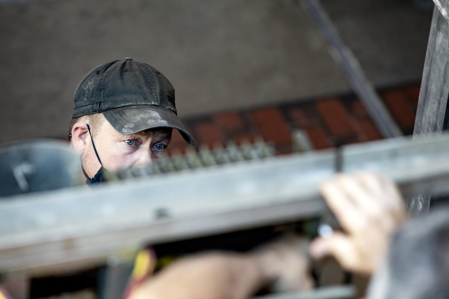 A foreman looks upward at a blurred view of the Mark I.