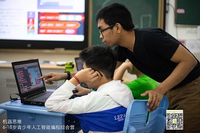 Malate helps a student with an engineering problem while teaching at a STEM camp in Suzhou, China.