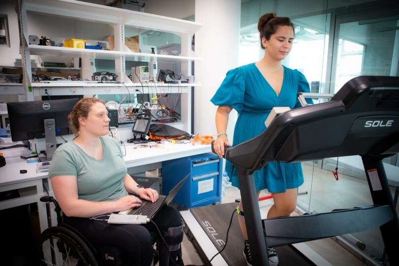 Elizabeth Suitor with labmate Sofia Cerasi walking on a treadmill at the Harvard Biodesign Lab.