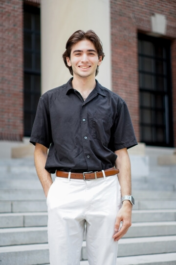 Harvard student Iñaki Arango, A.B. '25 standing in front of steps