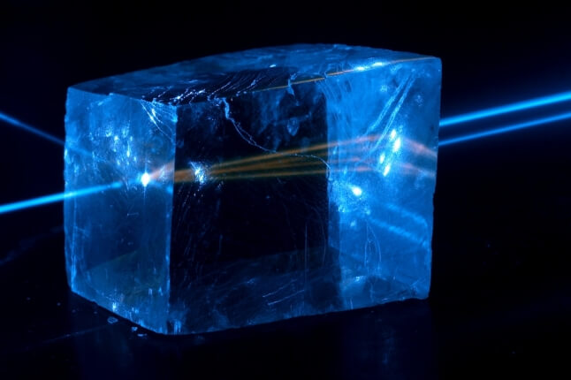 Light moving through birefringent calcite crystal 