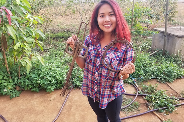Lily Xu holds a wildlife trap and snare