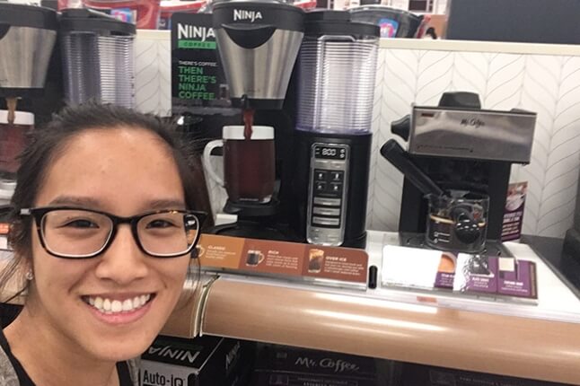 Stephanie Manivanh poses with a Ninja coffee maker