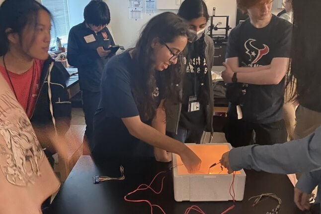 Students from Bellaire High School in Texas experiment with quantum superconductivity during the "Quantum Engineering Research and You" outreach program.