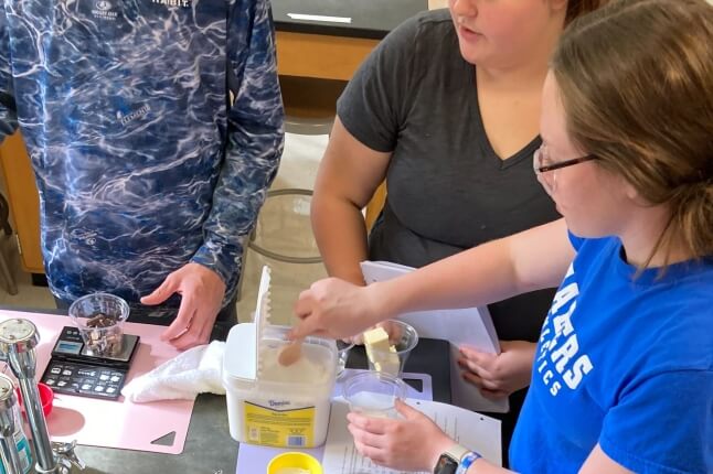 students cooking brownies in a high school lab